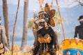 Unknown asian girl with painted face and ethnic costume while performance. Attractive unknown dancer. Asian tribal girl.