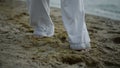 Unknown barefoot man stepping on beach closeup. Athlete exercising on seacoast Royalty Free Stock Photo