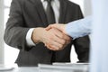 Unknown business man and woman are shaking hands finishing contract signing, close-up. Business and handshake concept Royalty Free Stock Photo