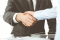 Unknown business man and woman are shaking hands finishing contract signing, close-up. Business and handshake concept Royalty Free Stock Photo