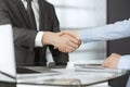 Unknown business man and woman are shaking hands finishing contract signing, close-up. Business and handshake concept Royalty Free Stock Photo