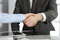 Unknown business man and woman are shaking hands finishing contract signing, close-up. Business and handshake concept Royalty Free Stock Photo