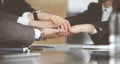 Unknown business people group joining hands in modern office. Businessmen and women making circle with their hands as a Royalty Free Stock Photo