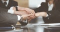 Unknown business people group joining hands in modern office. Businessmen and women making circle with their hands as a Royalty Free Stock Photo