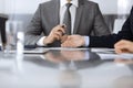 Unknown business people working together at meeting in modern office, close-up. Businessman and woman with colleagues or Royalty Free Stock Photo