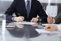 Unknown business people working together at meeting in modern office, close-up. Businessman and woman with colleagues or Royalty Free Stock Photo