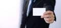 Unknown businessman hand holding business card with empty space, close-up Royalty Free Stock Photo