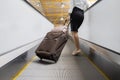 Unknown businesswoman standing on an escalator Royalty Free Stock Photo