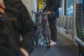 Unknown commuter with a bicycle inside a train or railway coach on his daily commute. Person traveling with a bicycle on a train