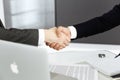 Unknown diverse business people are shaking hands finishing up meeting at the desk in office, close-up. Handshake Royalty Free Stock Photo