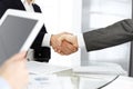 Unknown diverse business people are shaking hands finishing up meeting at the desk in office, close-up. Handshake Royalty Free Stock Photo