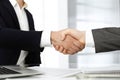 Unknown diverse business people are shaking hands finishing up meeting at the desk in office, close-up. Handshake Royalty Free Stock Photo