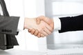 Unknown diverse business people are shaking hands finishing up meeting at the desk in office, close-up. Handshake Royalty Free Stock Photo