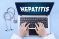 Unknown doctor with hepatitis word and laptop Royalty Free Stock Photo