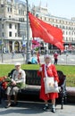 Unknown elderly woman with a red flag at the Moscow Bolshoi theatre on victory Day
