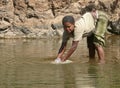 An unknown Ethiopian woman washes in the river in Roby, Ethiopia - November 23, 2008.