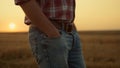 Unknown farmer walk empty field at gold sunset closeup. Harvest finish concept Royalty Free Stock Photo