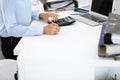 Unknown female bookkeeper or financial inspector calculating or checking balance, making report, close-up. Internal Royalty Free Stock Photo