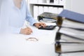 Unknown female bookkeeper or financial inspector calculating or checking balance, making report, close-up. Internal Royalty Free Stock Photo