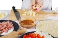 Unknown female chef holding slices mozzarella