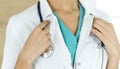 Unknown female doctor standing with stethoscope in clinic, close-up. Medicine concept Royalty Free Stock Photo