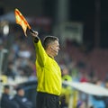 Unknown football referee performs during the soccer game