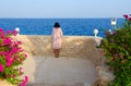 Unknown girl admires beautiful view at Stella Di Mare Sharm Beach Hotel & Spa 5 * in Naama Bay, Sharm El Sheikh, Egypt
