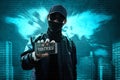 Anonymous hacker holding mobile phone Royalty Free Stock Photo