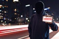 Hacker holding mobile phone on the street Royalty Free Stock Photo