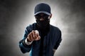 Anonymous hacker pointing on smoke background