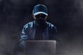 Unknown hacker use laptop in dark room