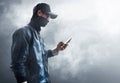 Anonymous hacker using mobile phone Royalty Free Stock Photo