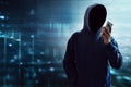 Anonymous hacker using mobile phone Royalty Free Stock Photo