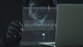 Hacker wearing black mask pulls SECURITY BREACH tab from a laptop Royalty Free Stock Photo