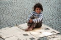 Unknown homeless kid sitting on the street Royalty Free Stock Photo