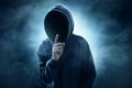 Hooded computer hacker on smoke background