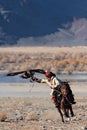 Unknown huntsman with Golden Eagle shows his experience in falconry.