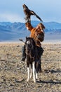 Unknown huntsman with Golden Eagle shows his experience in falconry.