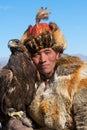 Unknown huntsman shows his Golden Eagle that is trained for falconry.