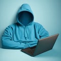 Unknown invisible man in a blue sweater sits in front of a laptop, invisible man, hacker, anonymous, man without a face,