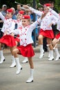Unknown junior majorettes in white and red costumes with batons