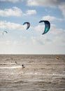 Kitesurfers surfing on brown water with waves from the Atlantic Ocean in La Rochelle, France