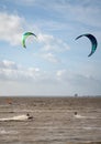 Unknown kitesurfers surf on brown water with waves from the Atlantic Ocean in La Rochelle, France Royalty Free Stock Photo