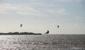 Unknown kitesurfers surf on brown water with waves from the Atlantic Ocean Royalty Free Stock Photo