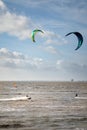 Unknown kitesurfers surf on brown water with waves from the Atlantic Ocean in La Rochelle, France Royalty Free Stock Photo