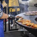 Unknown man cooking fish, seafood on barbecue grill, summer party Royalty Free Stock Photo