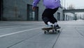 Unknown man feet riding on skate outdoor. Sporty guy making trick on longboard.