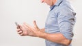 Unknown man holding his smart phone yelling in frustration at bad news Royalty Free Stock Photo