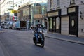 An unknown man rides a vintage retro Vespa scooter in the historical center of Vienna. Royalty Free Stock Photo