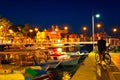 Unknown man watching people walking along pedestrian bridge in yacht marina of Marmaris old town